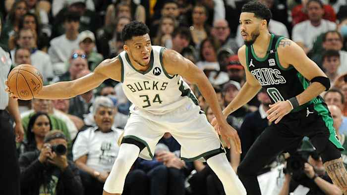 Milwaukee Bucks forward Giannis Antetokounmpo (34) is guarded by Boston Celtics forward Jayson Tatum.
